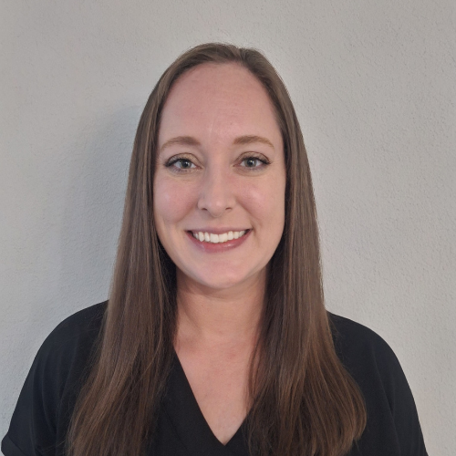 Image of Alexis Karas wearing a black shirt in front of a grey background